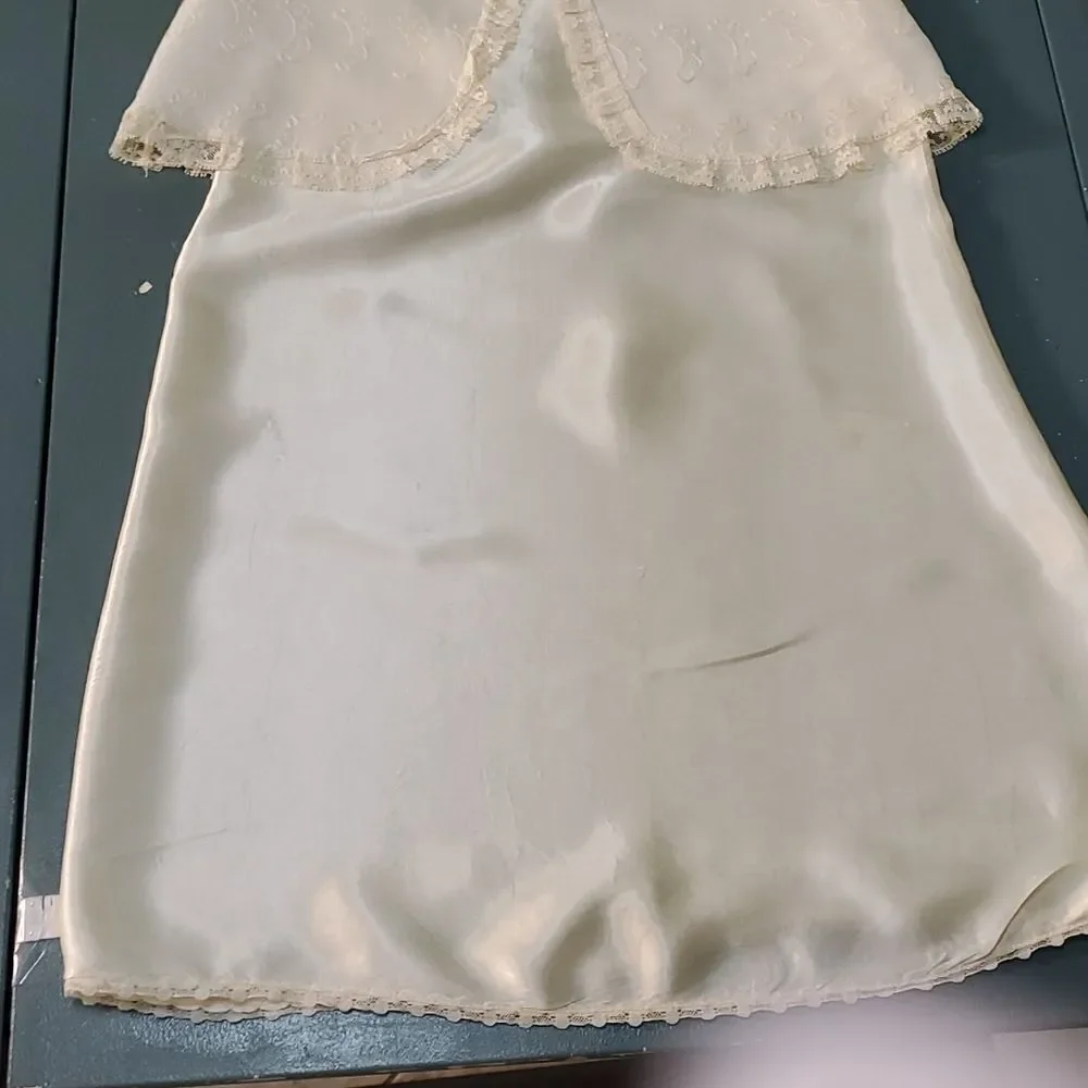 Vintage baby dress with jacket. Trimmed in lace with tie. The jacket has enbroid